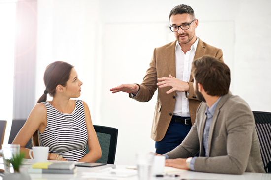 man talking to two people